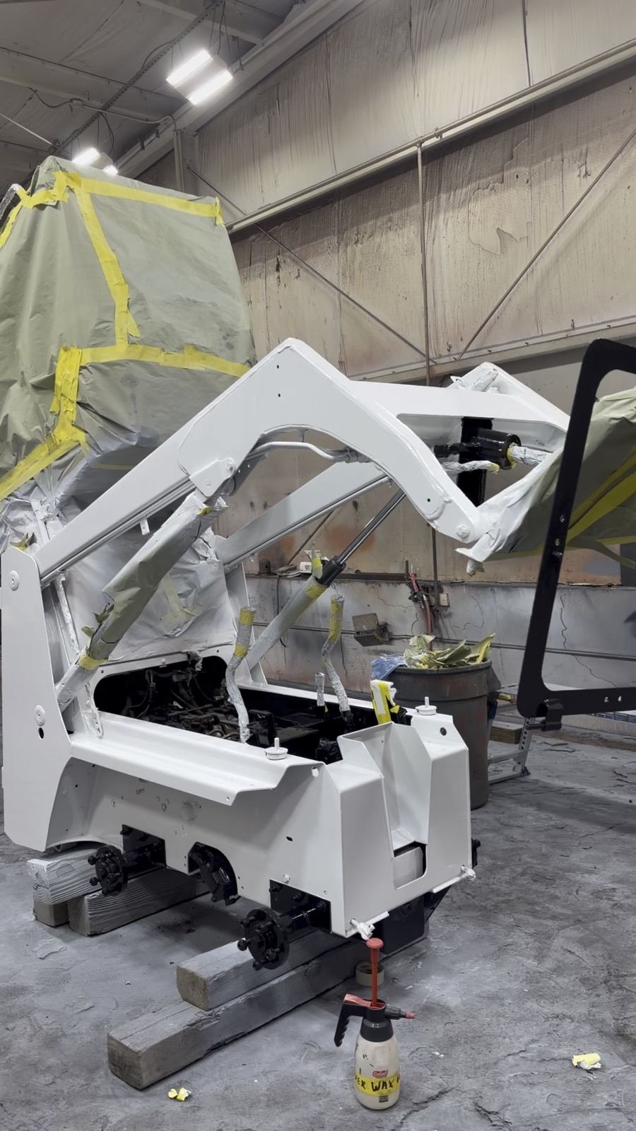 Skid steer in primer after blasting